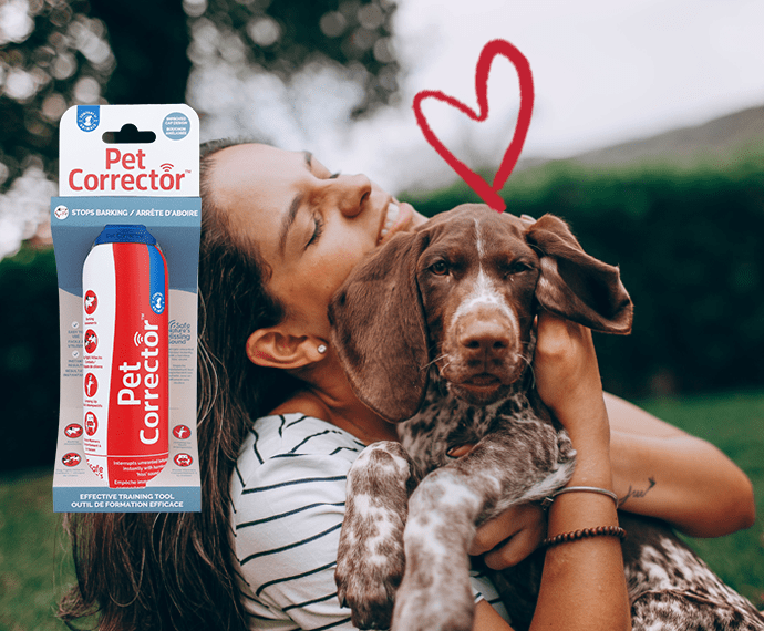 Company of Animals Pet Corrector spray in its pack, with a woman hugging her dog