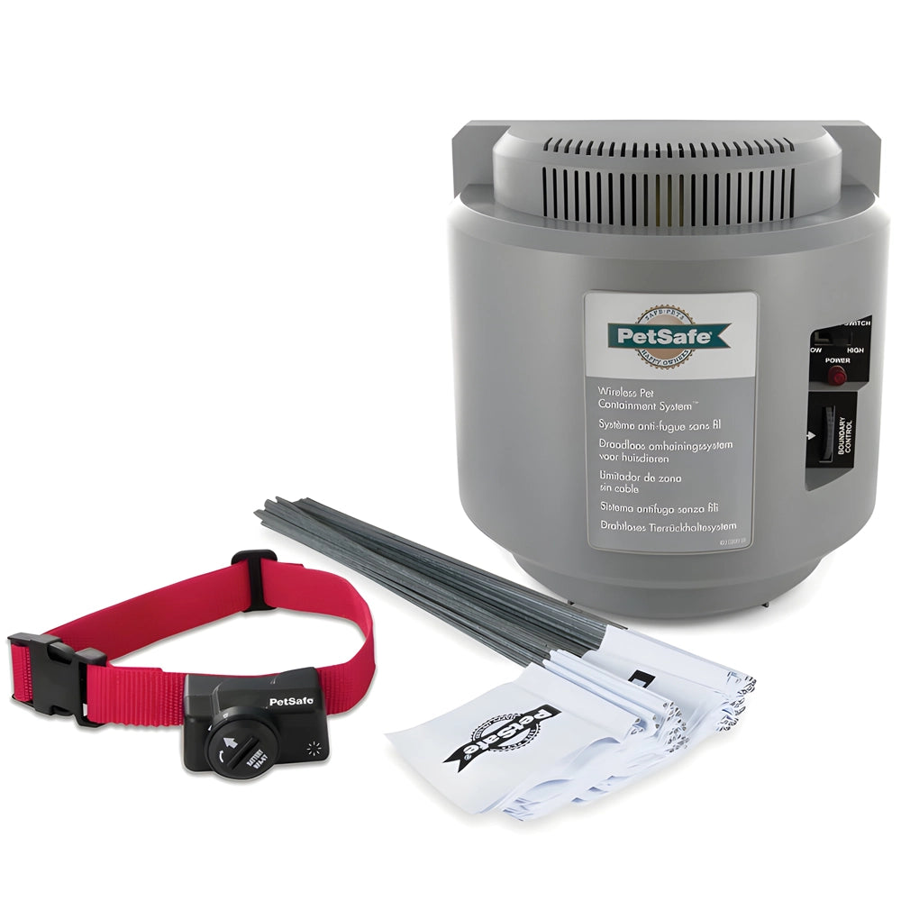 A PetSafe wireless radio fence system including a grey transmitter, a red and black receiver collar, a power adaptor, a test light tool, and a operating & training guide.